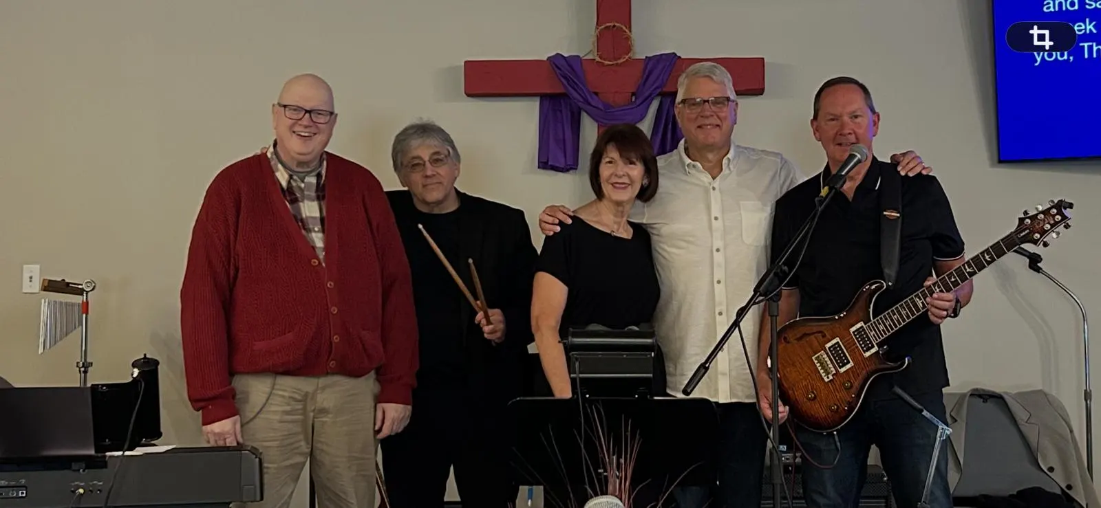 The Open Arms worship team standing together in the sanctuary